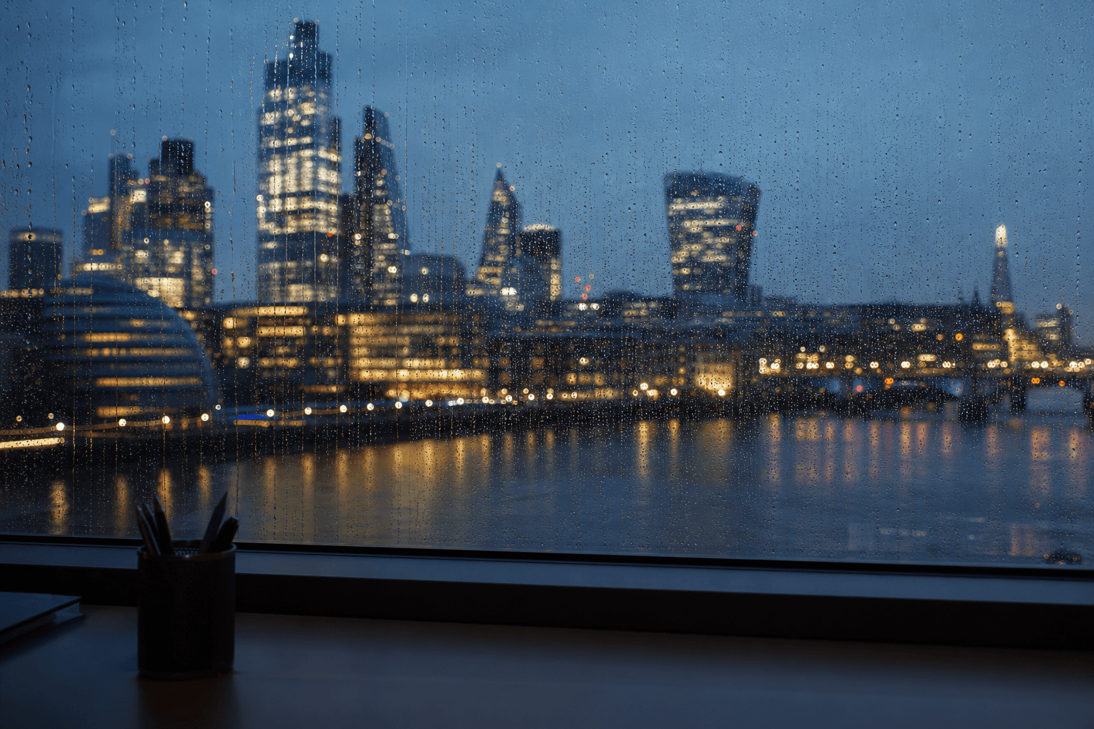 Evening London skyline through an office window